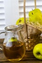 Green apples, basket with apples and jug with apple juice on wooden background Royalty Free Stock Photo