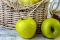 Green apples, basket with apples and jug with apple juice on wooden background Royalty Free Stock Photo