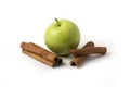 Green apples and cinnamons isolated on white background