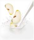 Green apples falling into the milky splash. Royalty Free Stock Photo