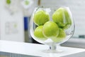 Green apples in a glass bowl on the table Royalty Free Stock Photo