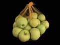Green apples in a grid isolated on black. Ripe fruits in a string bag. Apples with face pattern. Concept: joy, happiness, positive Royalty Free Stock Photo