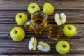 Green apples and jug with glass with apple juice on wooden background Royalty Free Stock Photo