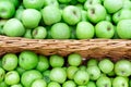 Green apples in the Market. Apples lie in boxes in front of the buyer. Healthy food