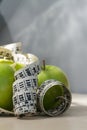 Green apples and measuring tape