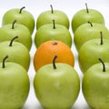 Green apples with one orange Royalty Free Stock Photo