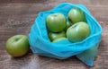 Green apples in reusable eco bags