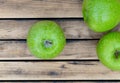 green apples on rustic wooden plank background