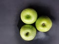 Three Granny Smith apples in water on a black background. Royalty Free Stock Photo