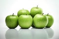 Green apples on a white background with a stem