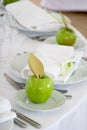 Green apples on white plates Royalty Free Stock Photo