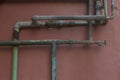 Green and Aqua Rusty Pipes on Coral Stucco Wall