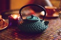 Green Arabic teapot on a mosaic table