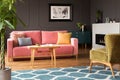 Green armchair and pink sofa in colorful living room interior wi Royalty Free Stock Photo