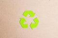 Green arrows recycle eco symbol on brown paper background Royalty Free Stock Photo