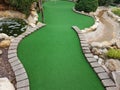 Green artificial grass and rocks on miniature golf course Royalty Free Stock Photo