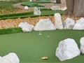 green artificial grass and rocks on miniature golf course Royalty Free Stock Photo