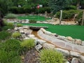 Green artificial grass and rocks on miniature golf course Royalty Free Stock Photo