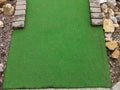 Green artificial grass and rocks on miniature golf course Royalty Free Stock Photo