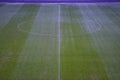 Green artificial grass soccer field with white line and center circle. Royalty Free Stock Photo