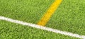 Green artificial grass turf soccer football field backgrond with white and yellow line boundary. Top view Royalty Free Stock Photo