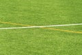 Green artificial grass turf soccer football field background with white and yellow line boundary. Top view Royalty Free Stock Photo