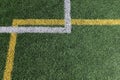 Green artificial grass turf soccer football field background with white and yellow line boundary. Top view Royalty Free Stock Photo