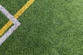 Green artificial grass turf soccer football field background with white and yellow line boundary. Top view Royalty Free Stock Photo