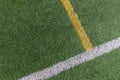 Green artificial grass turf soccer football field background with white and yellow line boundary. Top view Royalty Free Stock Photo