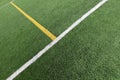 Green artificial grass turf soccer football field background with white and yellow line boundary. Top view Royalty Free Stock Photo