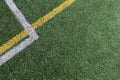 Green artificial grass turf soccer football field background with white and yellow line boundary. Top view Royalty Free Stock Photo