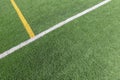 Green artificial grass turf soccer football field background with white and yellow line boundary. Top view Royalty Free Stock Photo