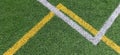 Green artificial grass turf soccer football field background with white and yellow line boundary. Top view Royalty Free Stock Photo