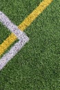 Green artificial grass turf soccer football field background with white and yellow line boundary. Top view Royalty Free Stock Photo