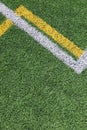 Green artificial grass turf soccer football field background with white and yellow line boundary. Top view Royalty Free Stock Photo