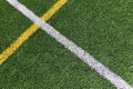 Green artificial grass turf soccer football field background with white and yellow line boundary. Top view Royalty Free Stock Photo