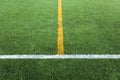 Green artificial grass turf soccer football field with white and yellow line boundary Royalty Free Stock Photo