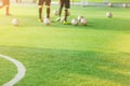 Green artificial turf with sunshine and blurry soccer players ba Royalty Free Stock Photo