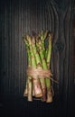 Green asparagus bundle on dark wooden background