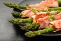 Green asparagus grilled with ham and cheese, served with garlic sauce. Royalty Free Stock Photo