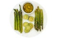 Green asparagus, sliced lemon, olive oil close up on marble serving board