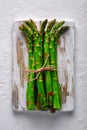 Green asparagus sprout on wooden plate