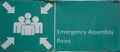 Green assembly point sign. Sign with a symbol that shows where people should gather in the event of an emergency. Royalty Free Stock Photo