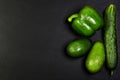 Green assortment vegetables, avocados, pepper and cucumber on a shale board, the concept of healthy eating, copy space, top view s