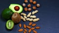Green assortment vegetables and fruits, avocados, kiwi and almonds, hazelnuts, peanuts, nuts on a shale board, the concept of heal