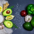 Green assortment vegetables and fruits, avocados, pepper and rucola salad on a shale board, Fitness food. Superfoods, top view