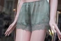 Green atin shorty on mannequin in fashion store showroom for women