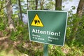 Green attention poison ivy sign in French and trees Royalty Free Stock Photo