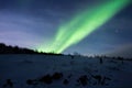 Green Aurora Borealis, northern lights over a hill in Norway Royalty Free Stock Photo