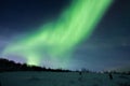 Green Aurora Borealis, northern lights over a hill in Norway Royalty Free Stock Photo